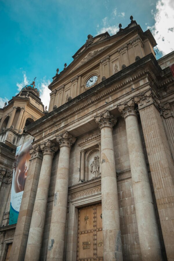 Low angle view of the historic Metropolitan Cathedral with neoclassical facade in Guatemala City.
