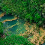 Lush tropical landscape with river and forest in Lanqúin, Guatemala.