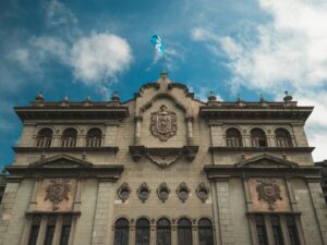 Stunning view of Guatemala's National Palace against a blue sky, highlighting its architectural beauty.