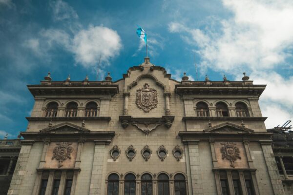 Stunning view of Guatemala's National Palace against a blue sky, highlighting its architectural beauty.